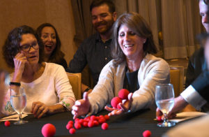 Woman at magic show with red foam balls
